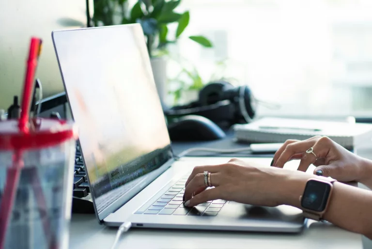 woman typing on laptop