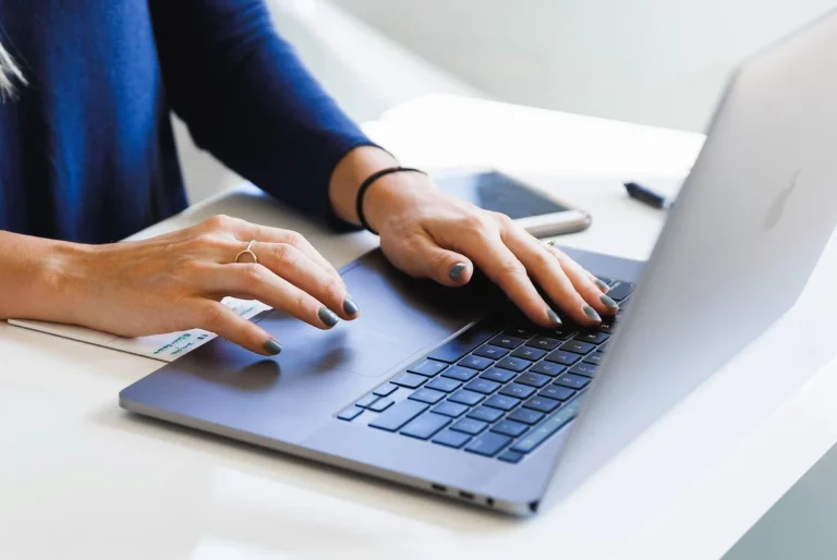 woman typing on laptop