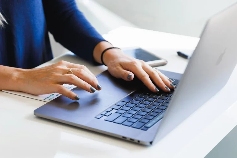 woman typing on laptop