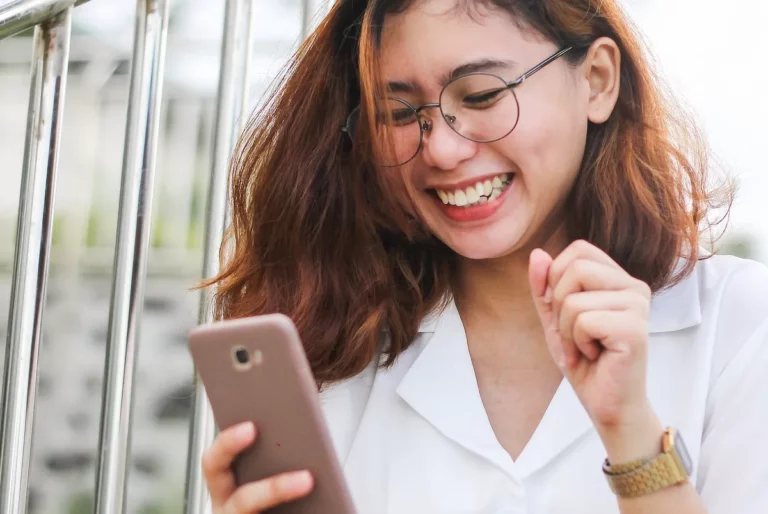 Student Discount Para Sa Load Act proposed in House young woman holding a phone