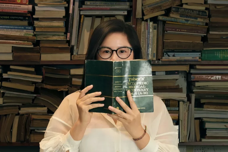 young woman holding book